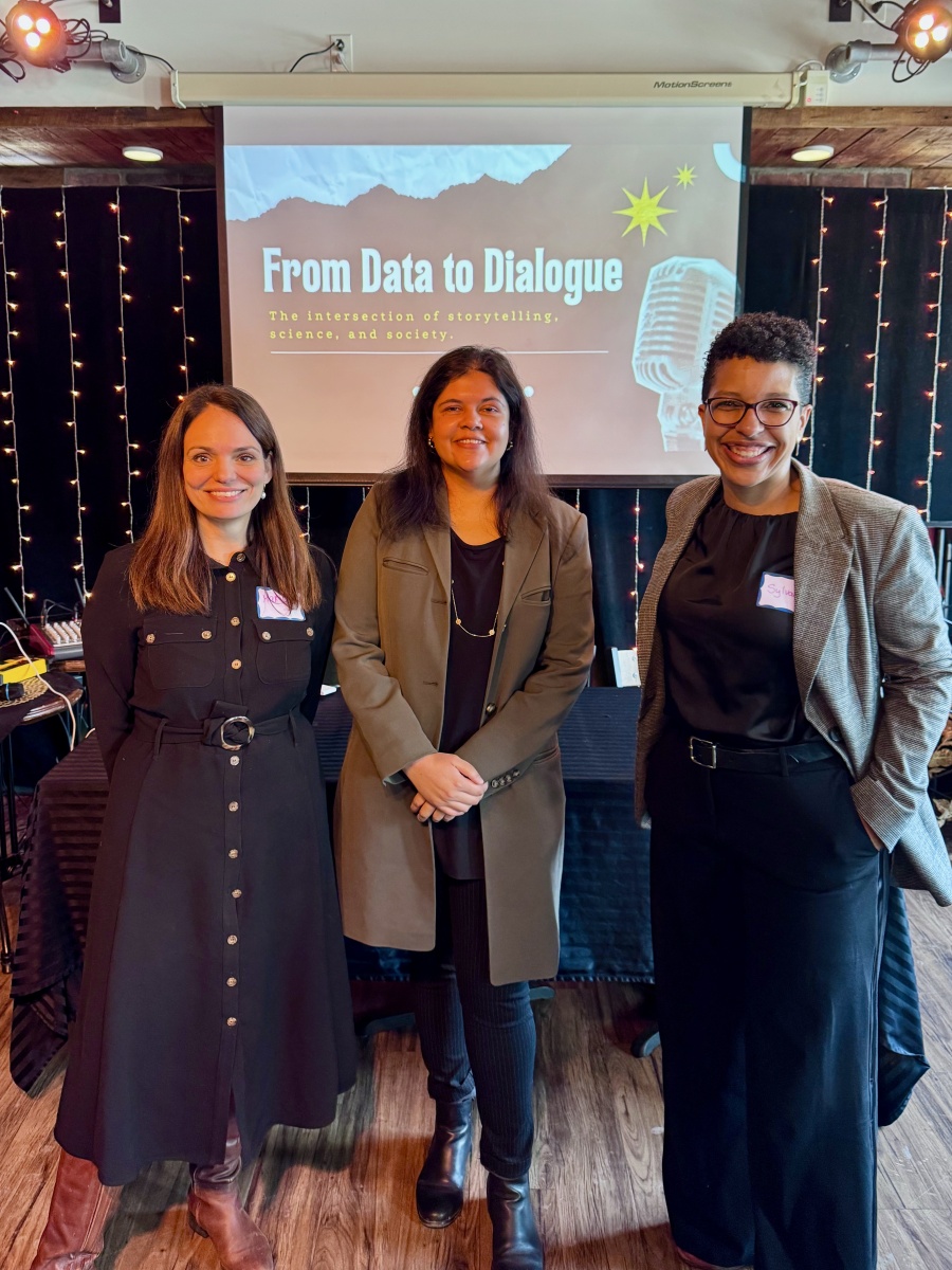Three women standing at event on storytelling in science