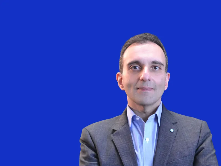 Headshot of Ahmed Abdulla on blue backround